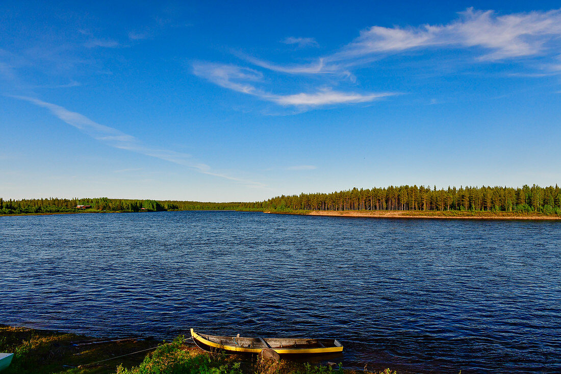 A rowing boat lies on the banks of the Torneälv, near Lovikka, Norrbotten County, Sweden