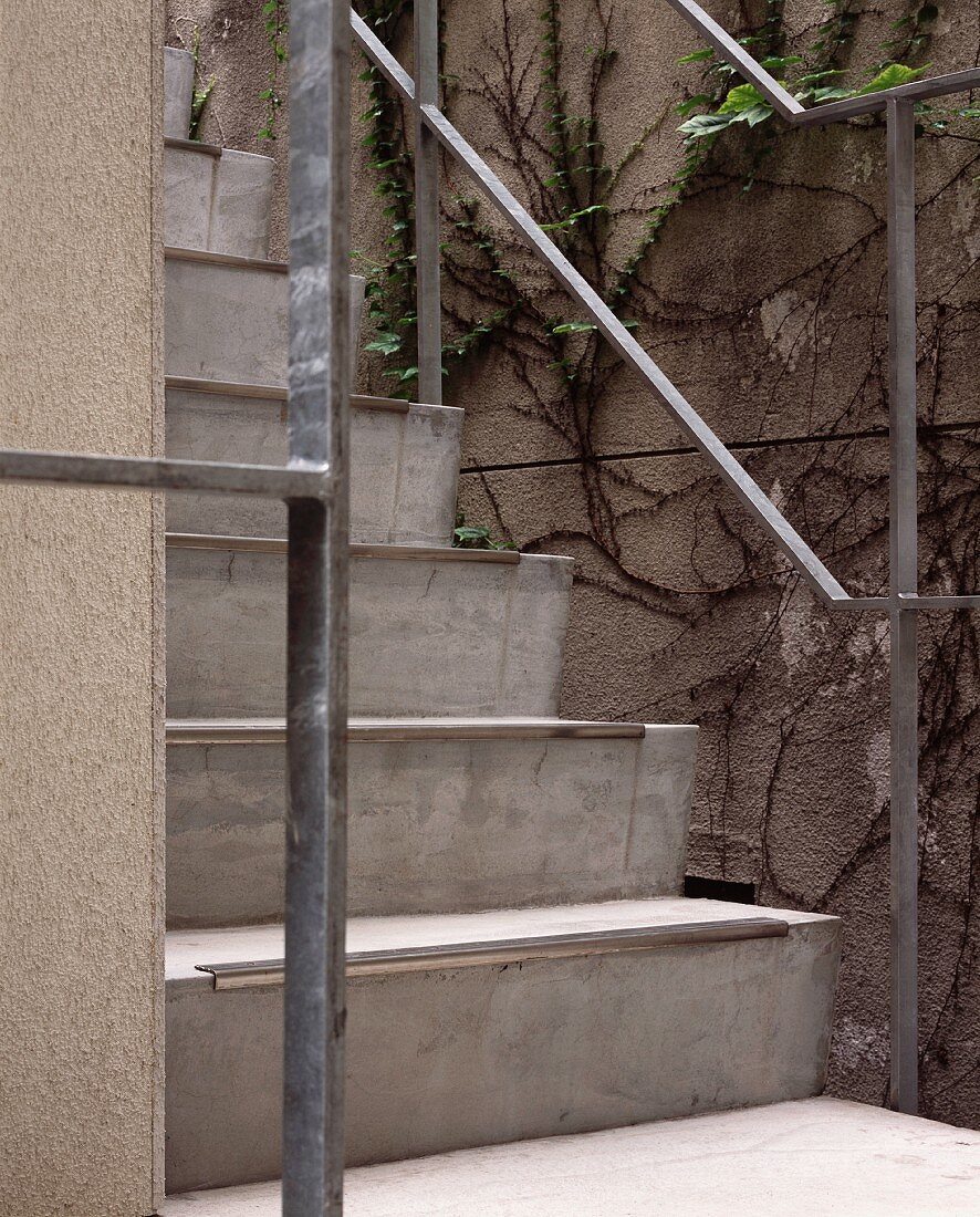 Concrete steps with a metal banister outside