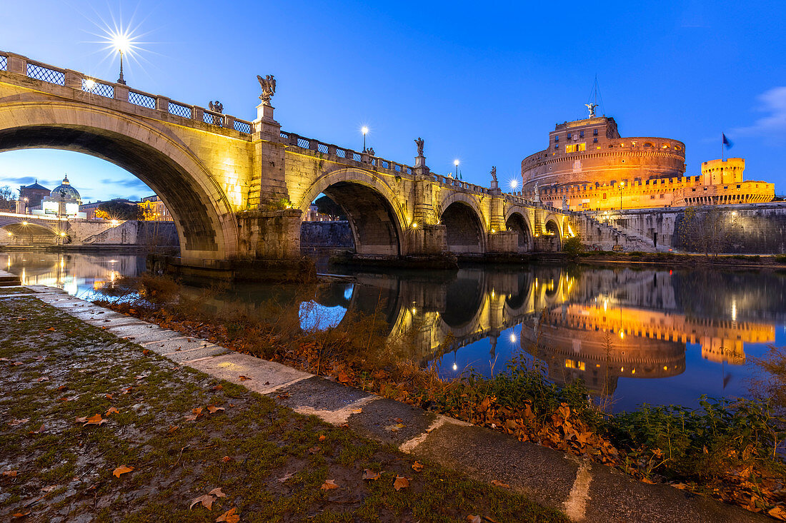 Blue hour in Rome in front of the Sant'Angelo bridge, the Tevere river and Castel Sant'Angelo. Rome, Rome district, Lazio, Europe, Italy.