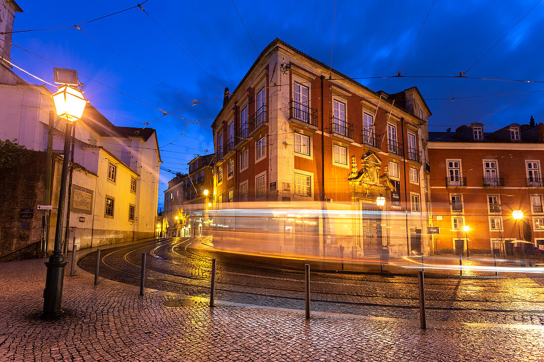 A tram pass on the streets of Alfama district in the evening in front of the Museum of Decorative Arts. Lisbon, Portugal, Europe.