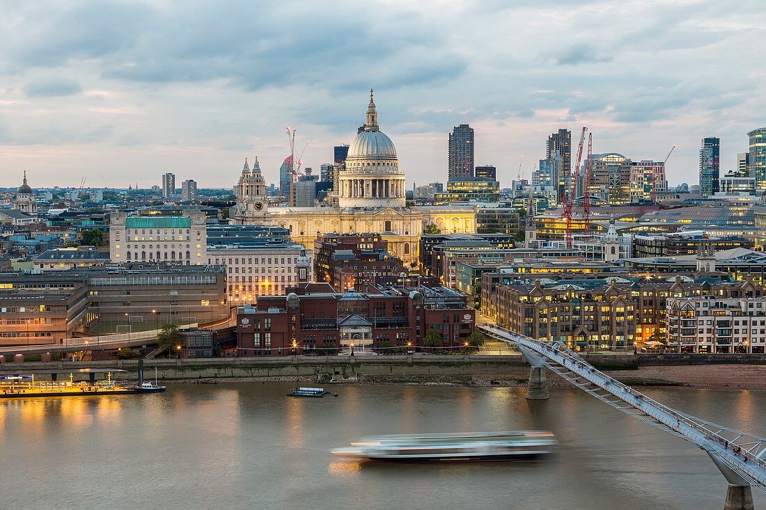 United Kingdom, London, Millenium Bridge of the architect Norman Foster with the City in the background with the Cathedral of St. Paul at nightfall