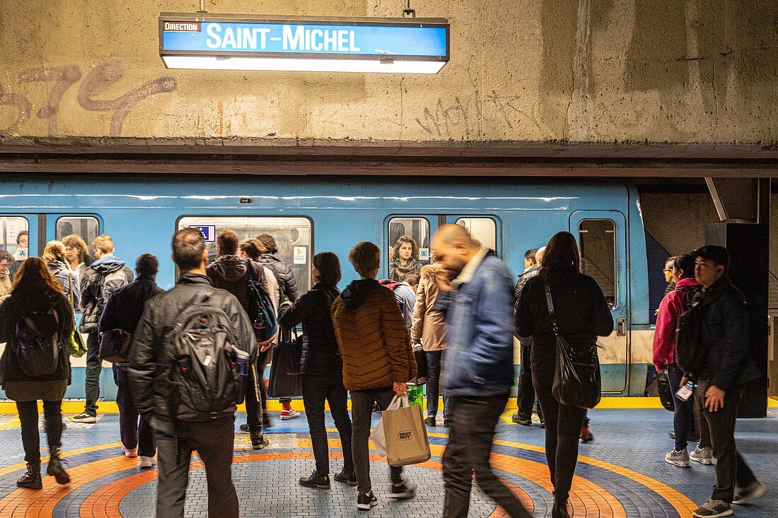 TRAVELLERS AT THE SAINT-MICHEL METRO STATION, MONTREAL, QUEBEC, CANADA