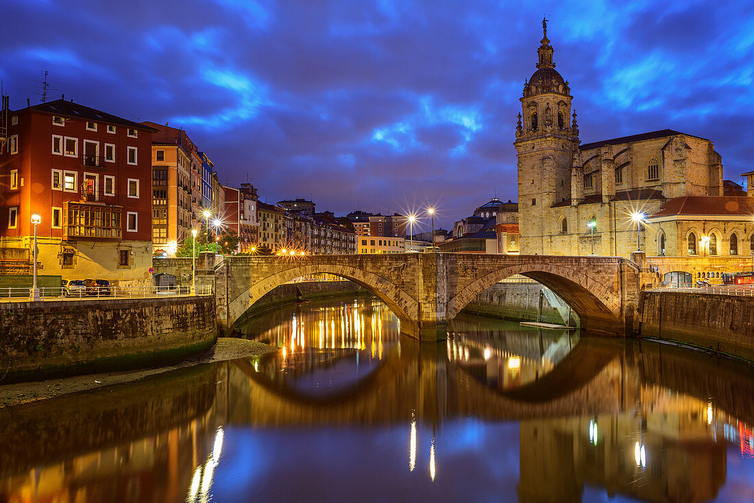 Illuminated old town of Bilbao with San Anton cathedral on Nervion river, Bilbao, Basque Country, Spain