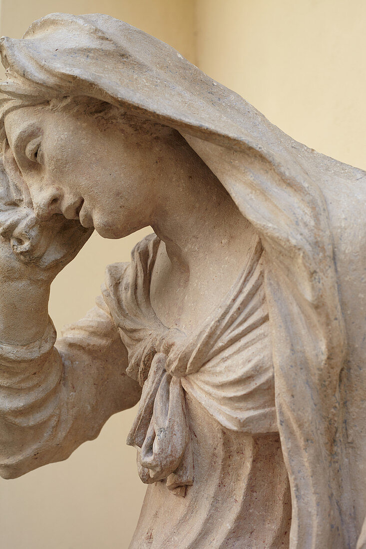 Weeping woman statue in a courtyard, Bratislava, Slovakia.