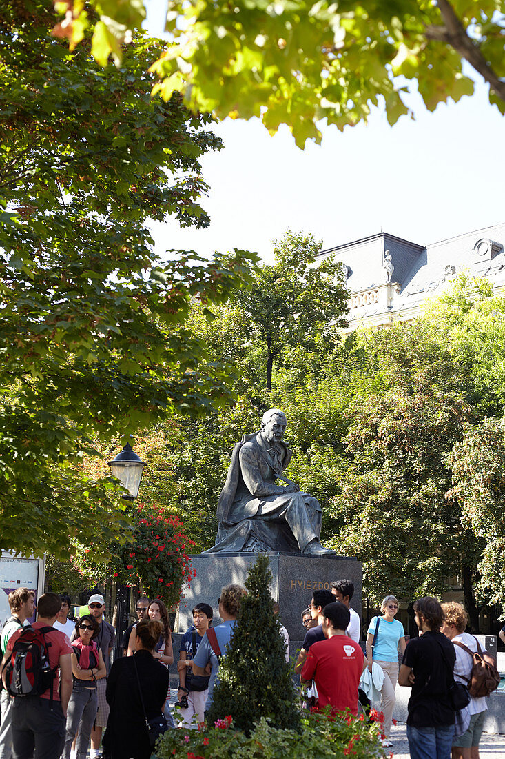 Tour group at the Hviezdoslav Monument in Hviezdoslav Square, Bratislava, Slovakia.