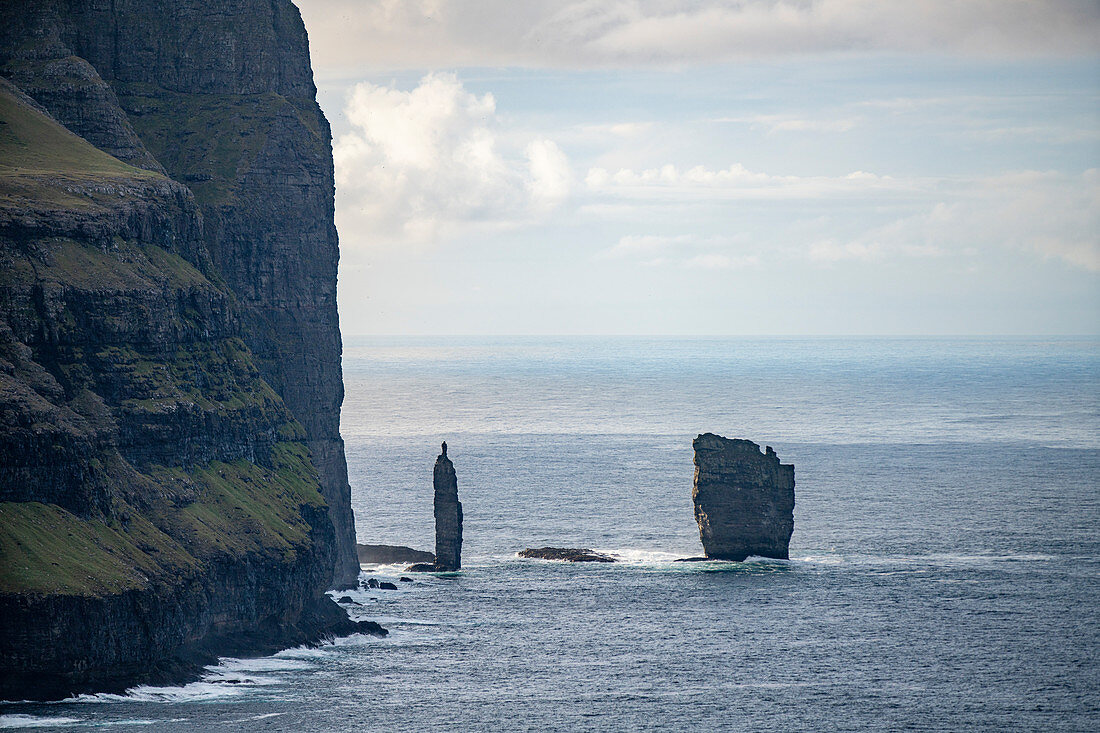 Rock needles in the sea in front of the Eiði, Eysturoy, Faroe Islands,