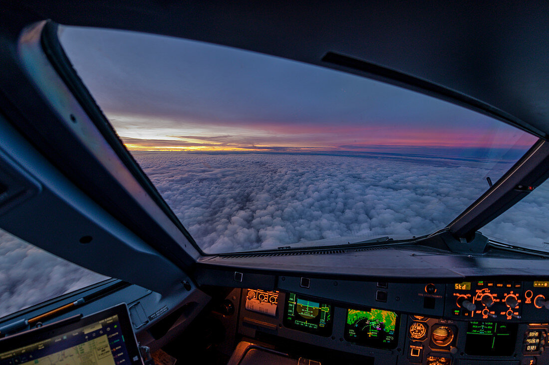 View out of the cockpit of an Airbus A320 during sunrise