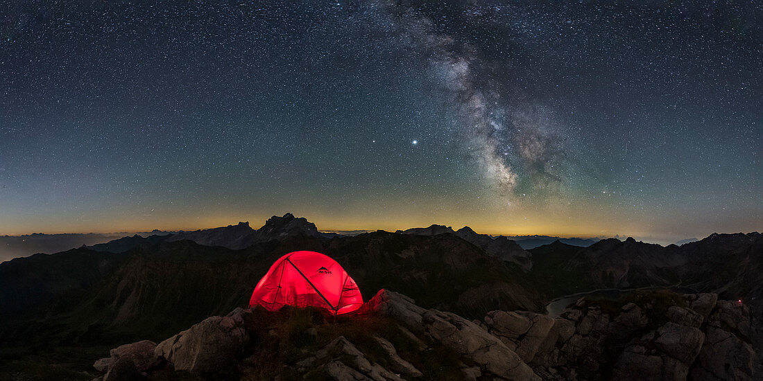 Camping under the Milky Way on a summit in the Austrian Alps