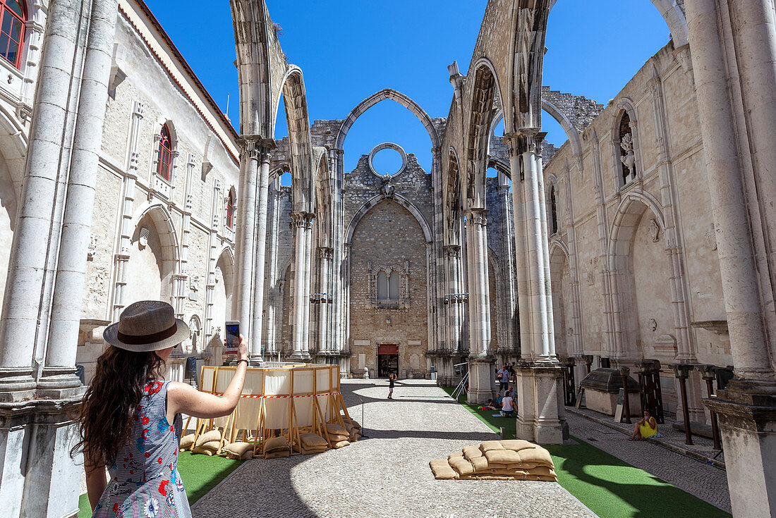 Ein Tourist fotografiert das Innere des Klosters Igreja do Carmo (Kloster Carmo), Stadtviertel Chiado, Lissabon, das Dach der Kirche stürzte nach dem Erdbeben von 1755 ein