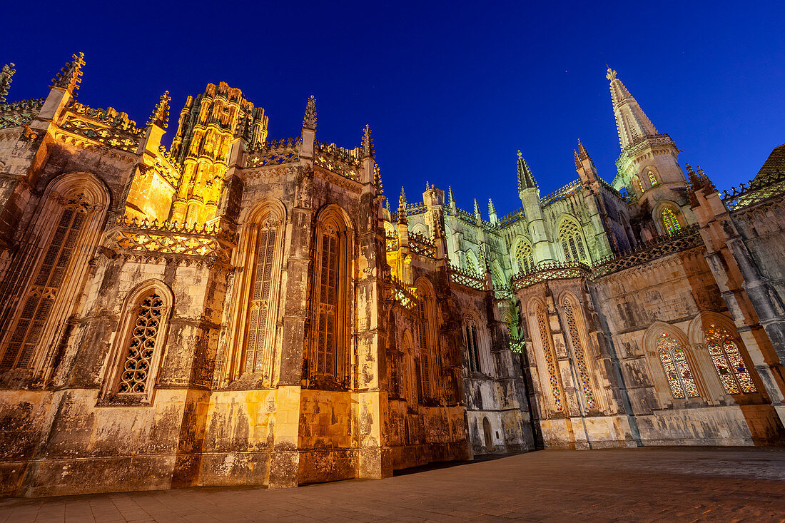 The Gothic forms of Batalha Monastery illuminated in the evening, Batalha municipality, Leiria district, Estremadura province, Portugal.