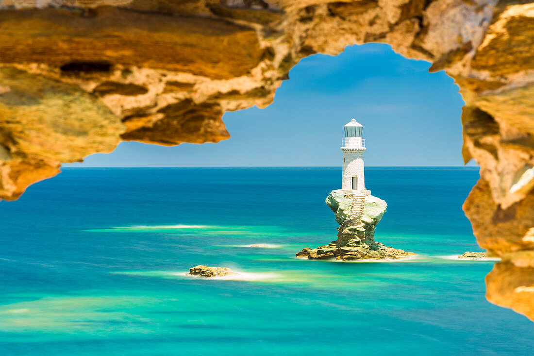 Tourlitis lighthouse framed in a rock window, Andros, Cyclades Archipelago, Greece, Europe