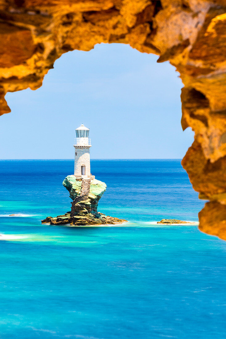 Tourlitis lighthouse framed in a rock window, Andros, Cyclades Archipelago, Greece, Europe