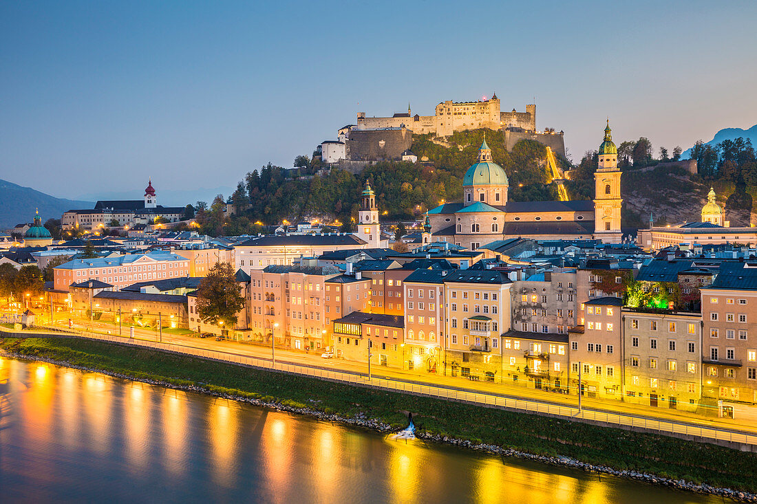 Historical old town of Salzburg reflected in Salzach river at dusk with Hohensalzburg Fortress in the background, Salzburg, Salzburger Land, Austria, Europe