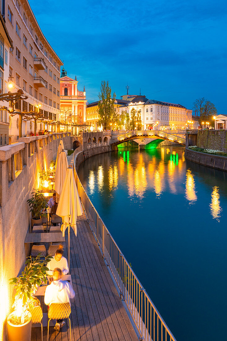 Old town and triple bridge reflected on Ljubljanica river. Ljubljiana, Osrednjeslovenska, Slovenia