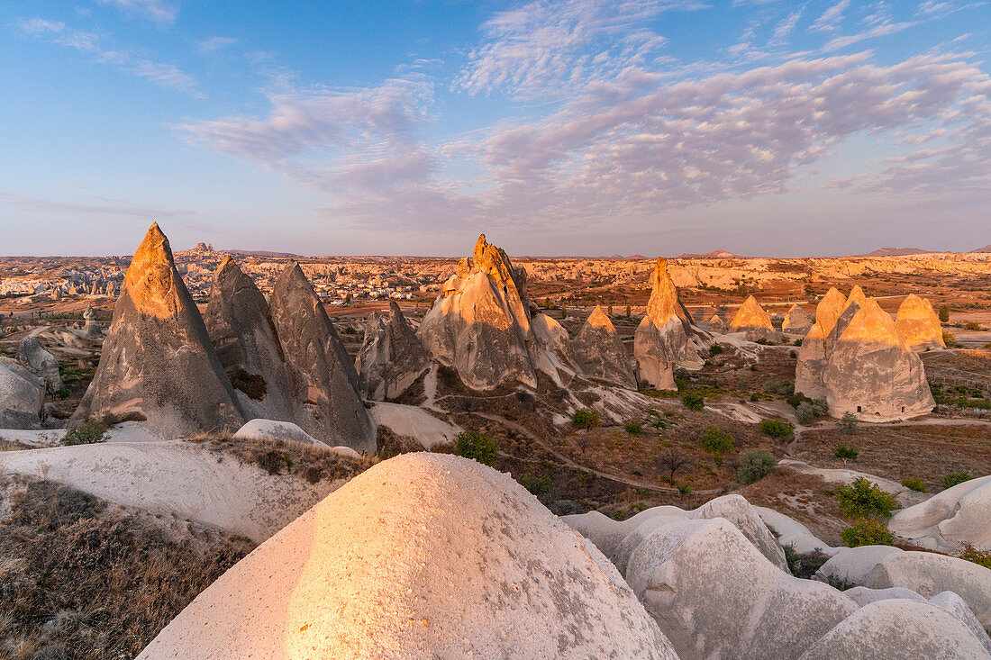 Tuff rock formations landscape at sunrise. Rose valley, Goreme, Capadocia, Kaisery district, Anatolia, Turkey.