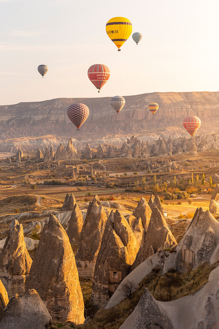 Hot air balloons over the rock tuff formations of Goreme. Capadocia, Kaisery district, Anatolia, Turkey. 