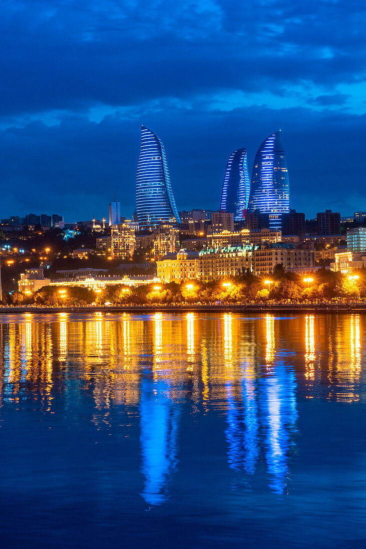 Flame towers cityscape at dusk from Caspian seafront. Baku, Azerbaijan, Central Asia.