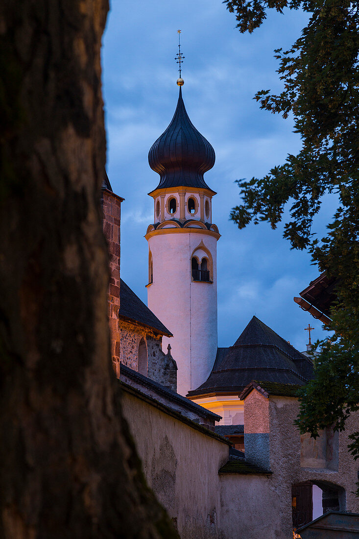 The medioeval Collegiata dei Santi Candido and Corbiniano church in the alpine village of San Candido during twilight. San Candido, Pusteria valley, Bolzano district, Dolomites, Trentino Alto Adige, Italy, Europe.