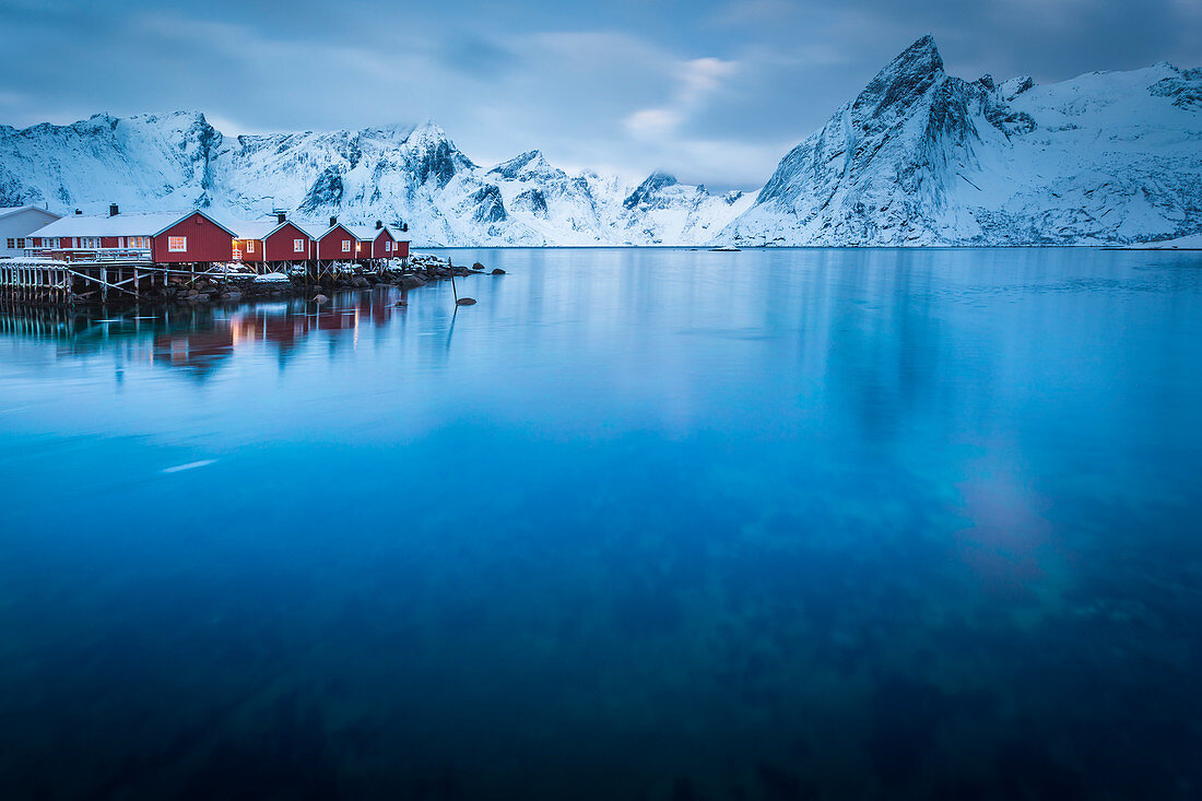 Typical red houses reflected in the sea. Reine, Lofoten Islands, Northern Norway 