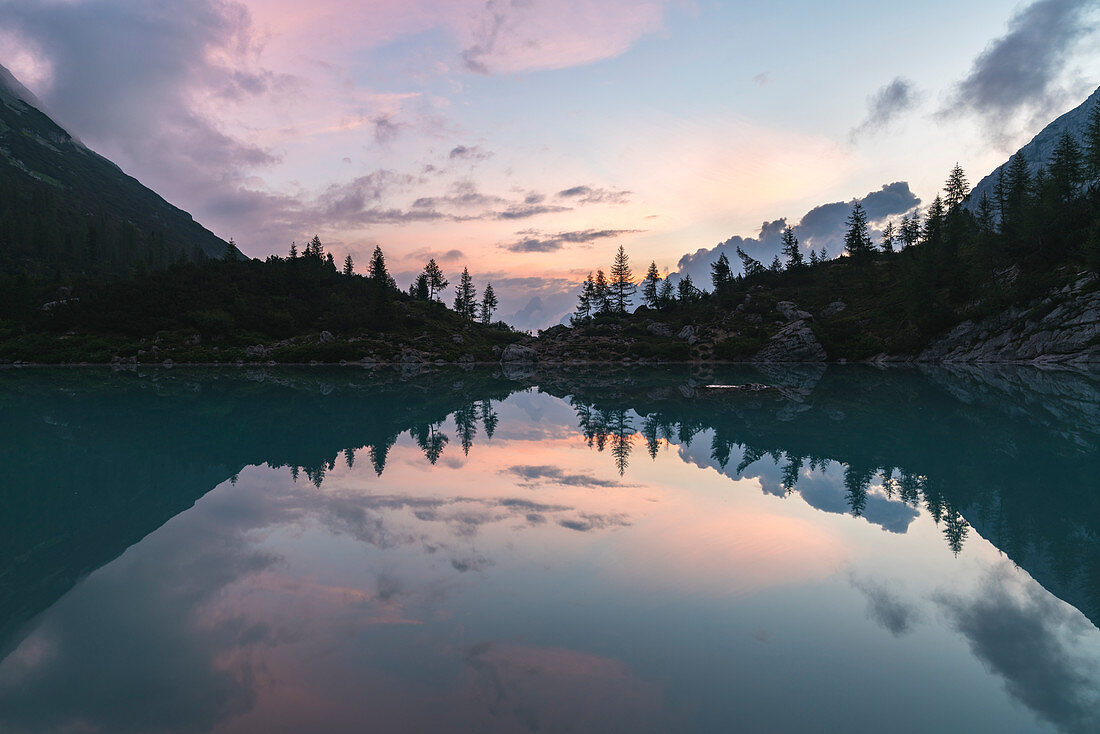 Sunset clouds over Sorapis Lake in summer. Cortina d'Ampezzo, Belluno province, Veneto, Italy.