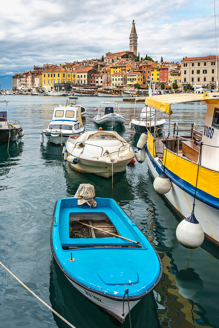 Fishing boats at the harbour with the old town in the background. Rovinj, Istria county, Croatia.