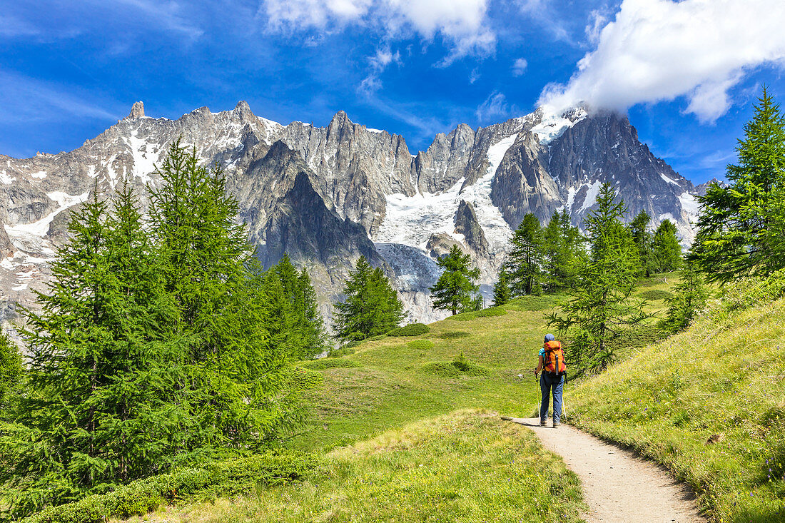 A trekker is walking to the Bonatti Refuge during the Mont Blanc hiking tours (Ferret Valley, Courmayeur, Aosta province, Aosta Valley, Italy, Europe) (MR)\n
