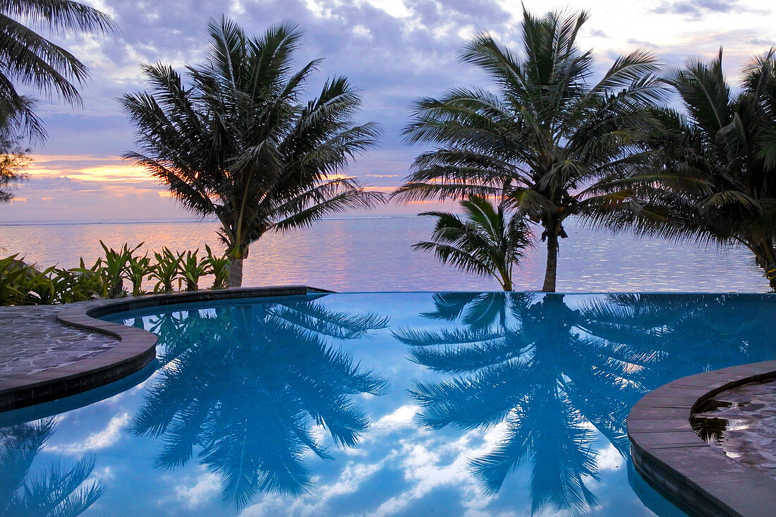 Empty swimming pool in a tropical island resort at sunrise in Rarotonga , Cook Islands.
