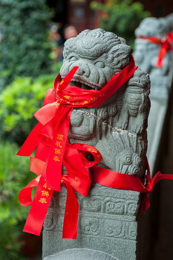 Red prayer ribbons in the courtyard of the Jade Buddha Temple, a Buddhist temple in Shanghai, China.