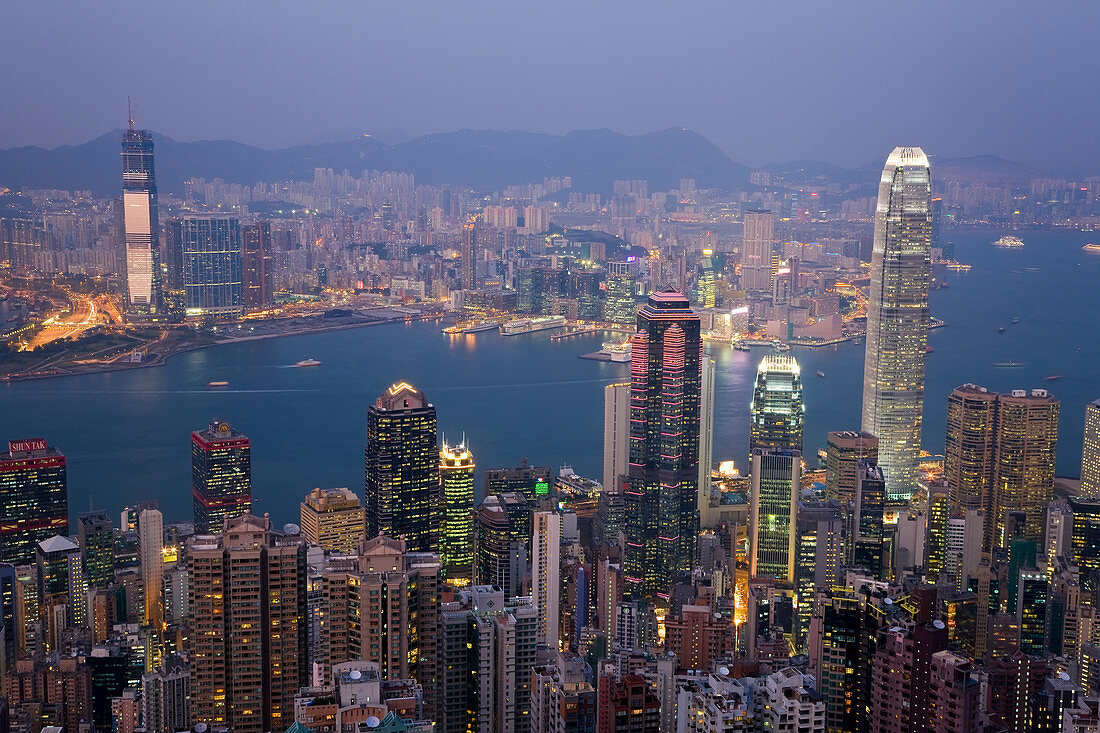 View from Victoria Peak across harbour at dusk, Hong Kong, China