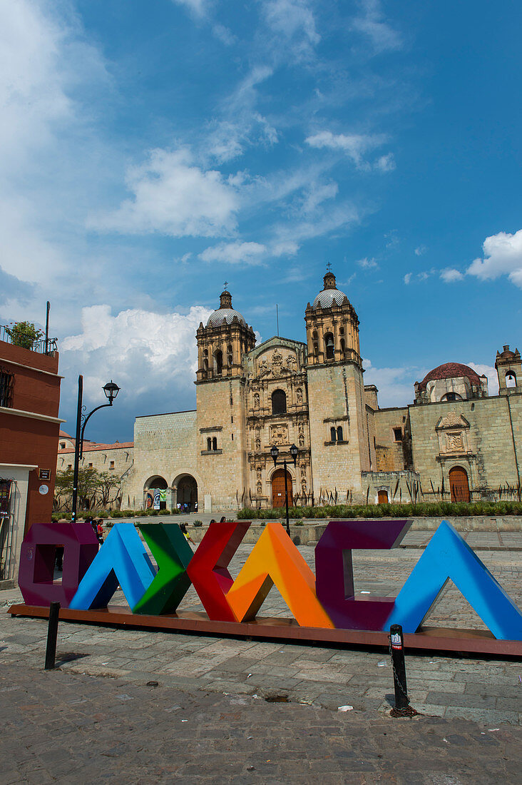 Plaza Santo Domingo mit bunten Buchstaben OAXACA und der Kirche von Santo Domingo de Guzman im Hintergrund in Oaxaca de Juarez, Mexiko.