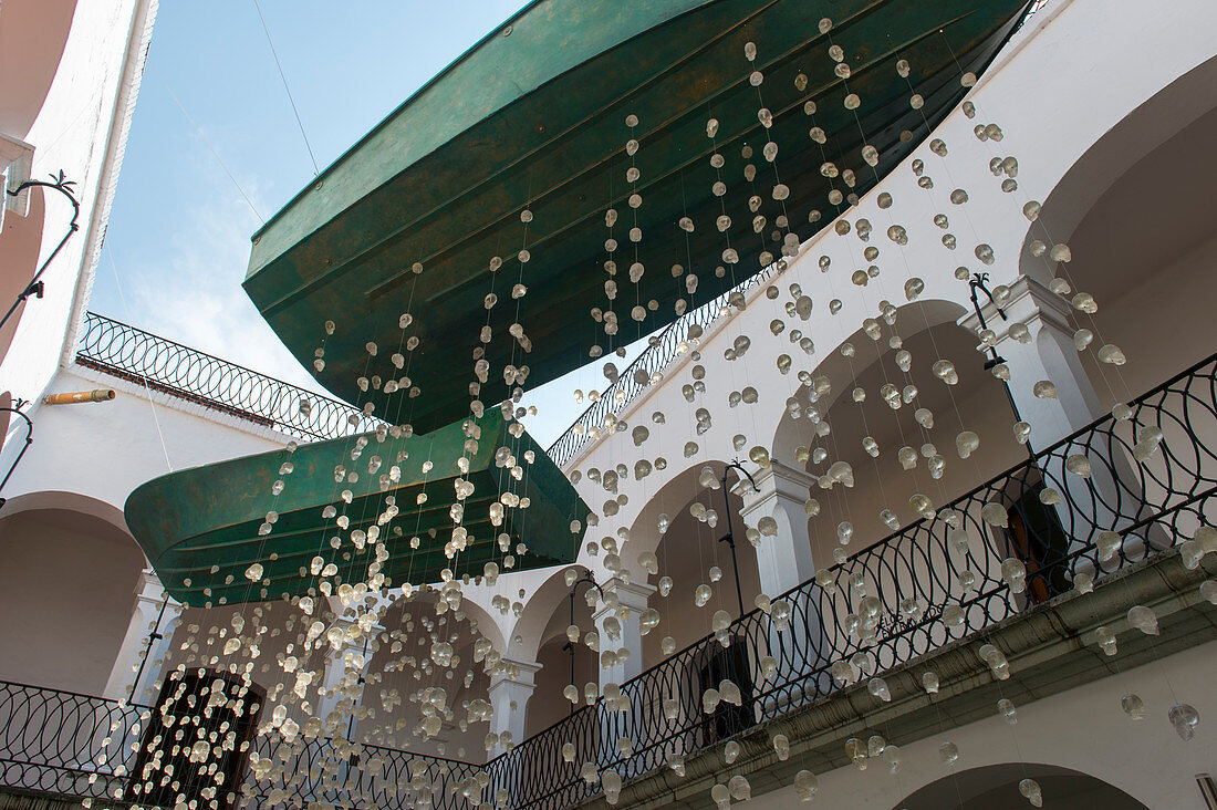 Glass skulls hanging on strings in the courtyard of the Museo de los Pintores Oaxaquenos in Oaxaca City, Mexico.