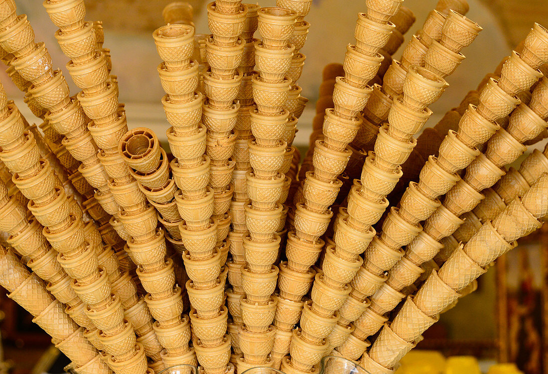 Many stacked ice cream cones as decoration in an ice cream parlor, Assisi, Italy