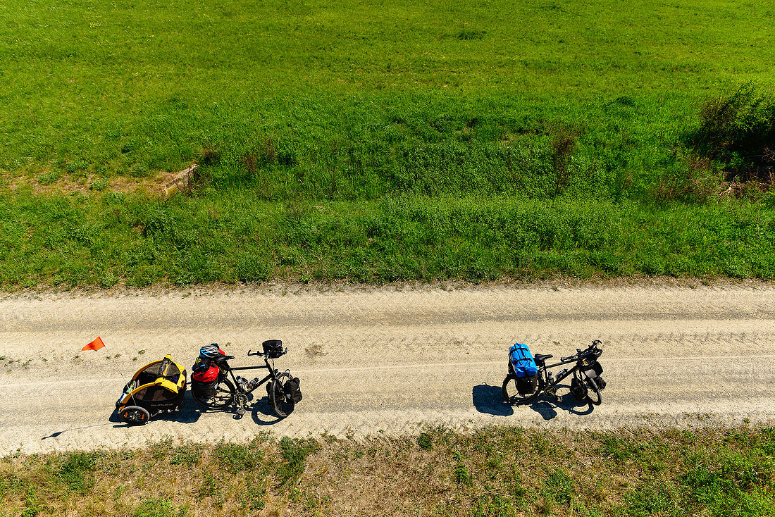View from a tower on a dirt road, touring bikes with dog trailers, Breitenbrunn, Austria