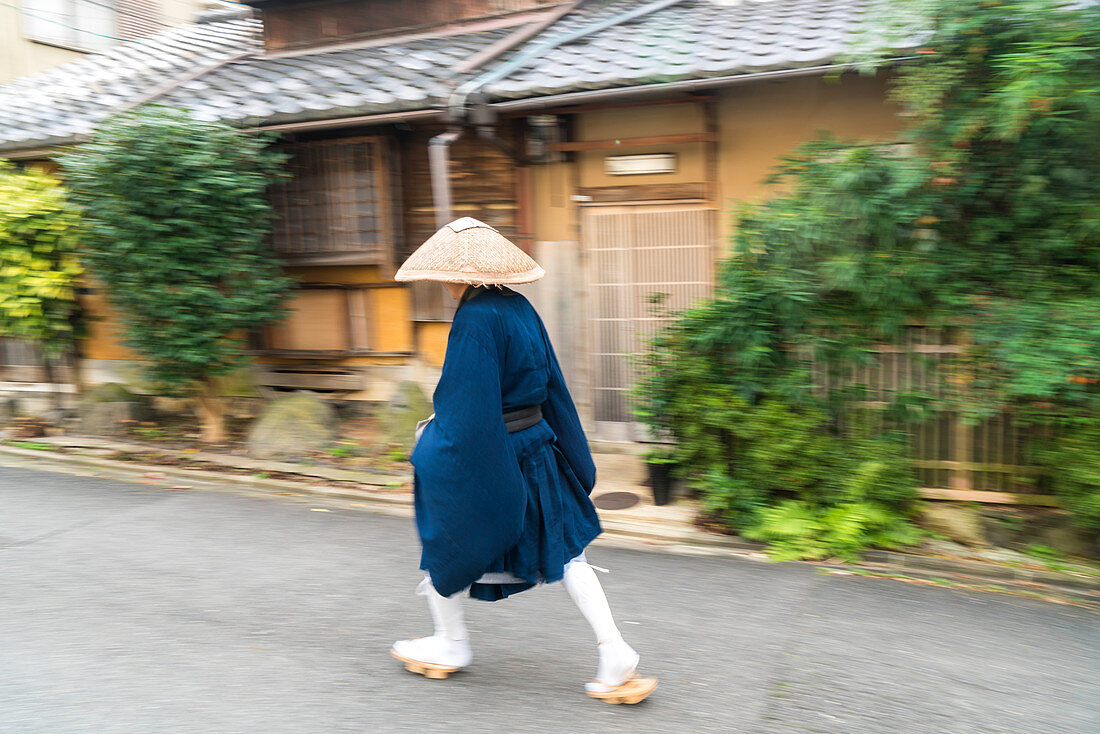 Shinto monk walking along the street in Kyoto, Japan