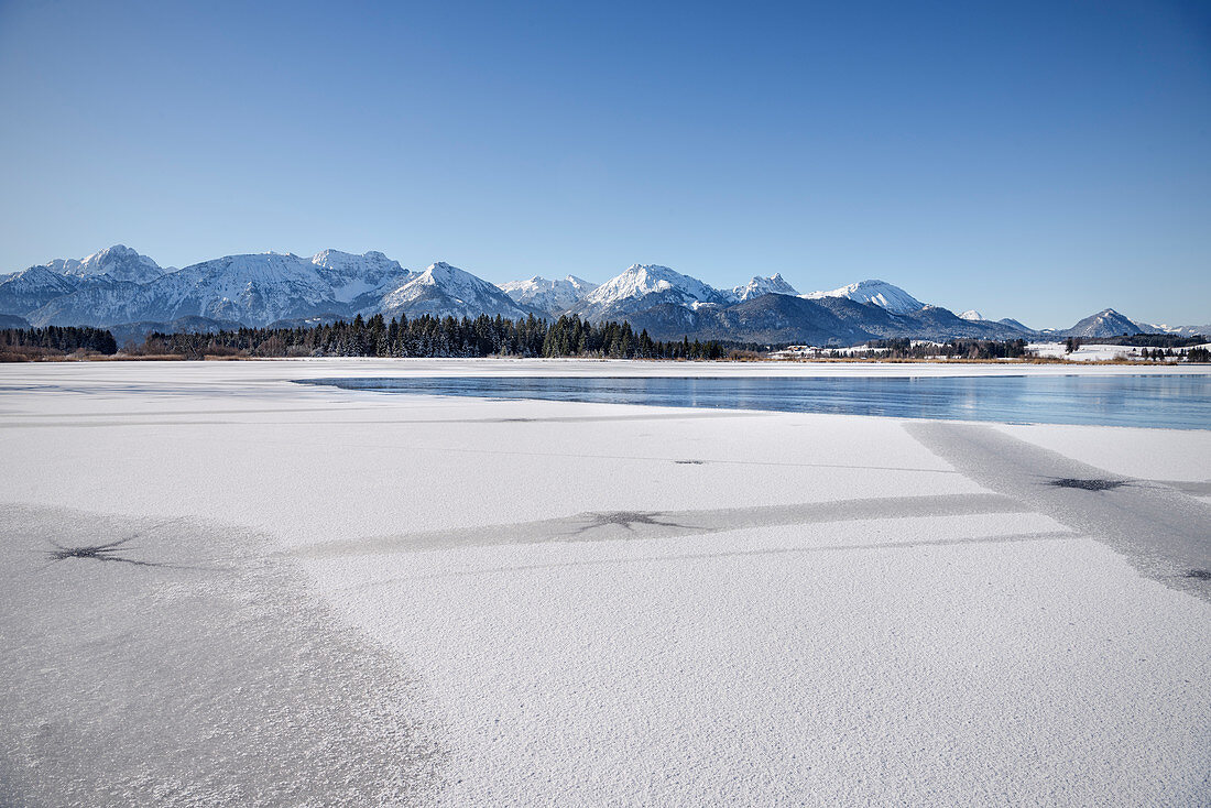 Frozen Hopfensee in winter, Hopfen am See, Füssen, Ostallgäu, Bavaria, Germany