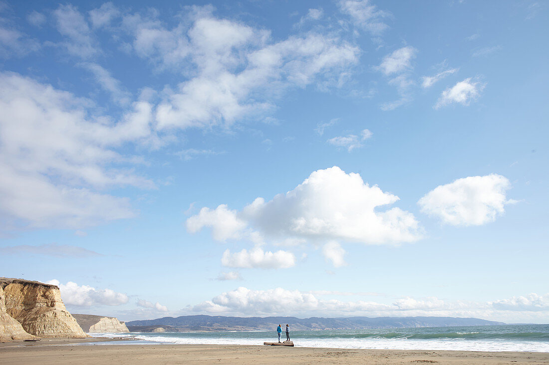 Two girls on the beach at Point Reyes, California, USA.