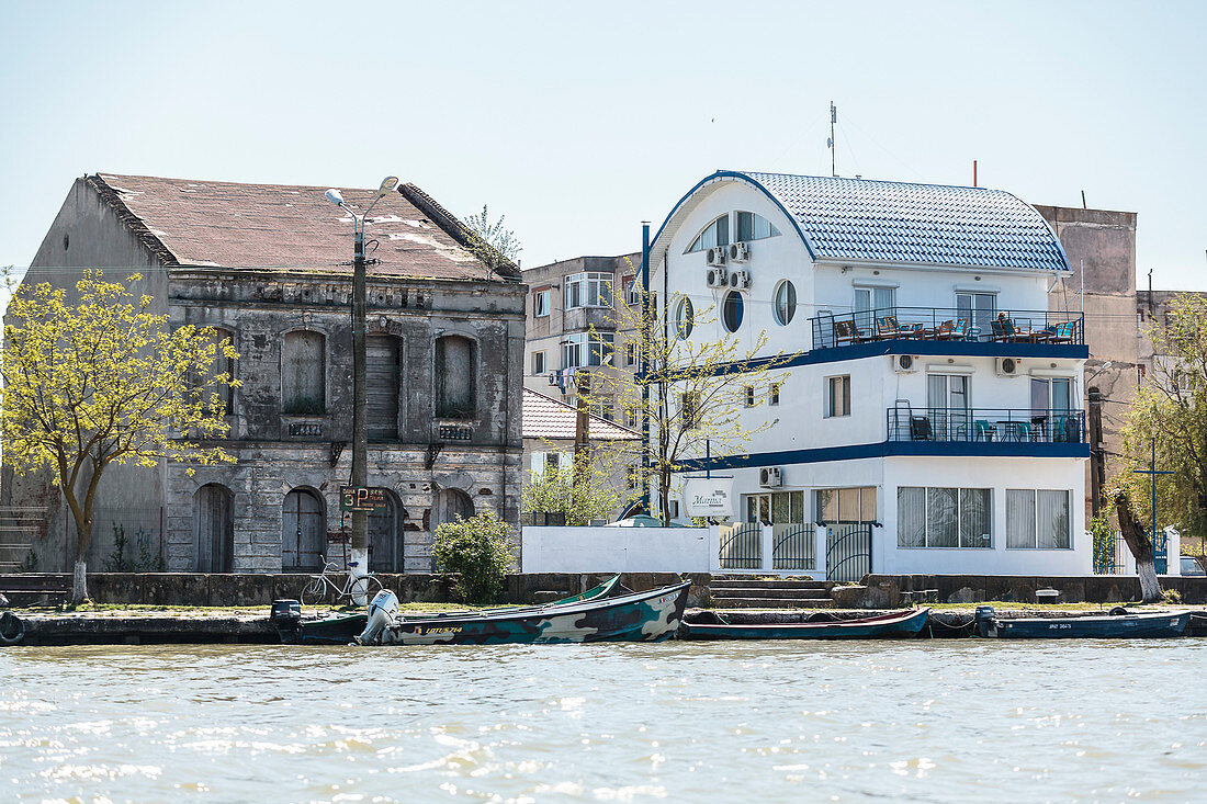 Danube Delta, old and new buildings on the banks of Sulina, Tulcea, Romania.
