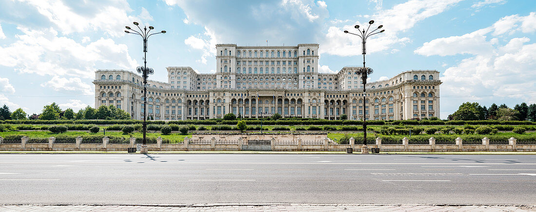Parliament Palace of Romania, in front of it Bulevardul Libertatii in the capital Bucharest. Formerly called House of the People / Casa Poporului. Erected by the dictator Nicolae Ceausescu as a monument of power, it is the second largest administrative building in the world and the seat of the Romanian Chamber of Deputies.