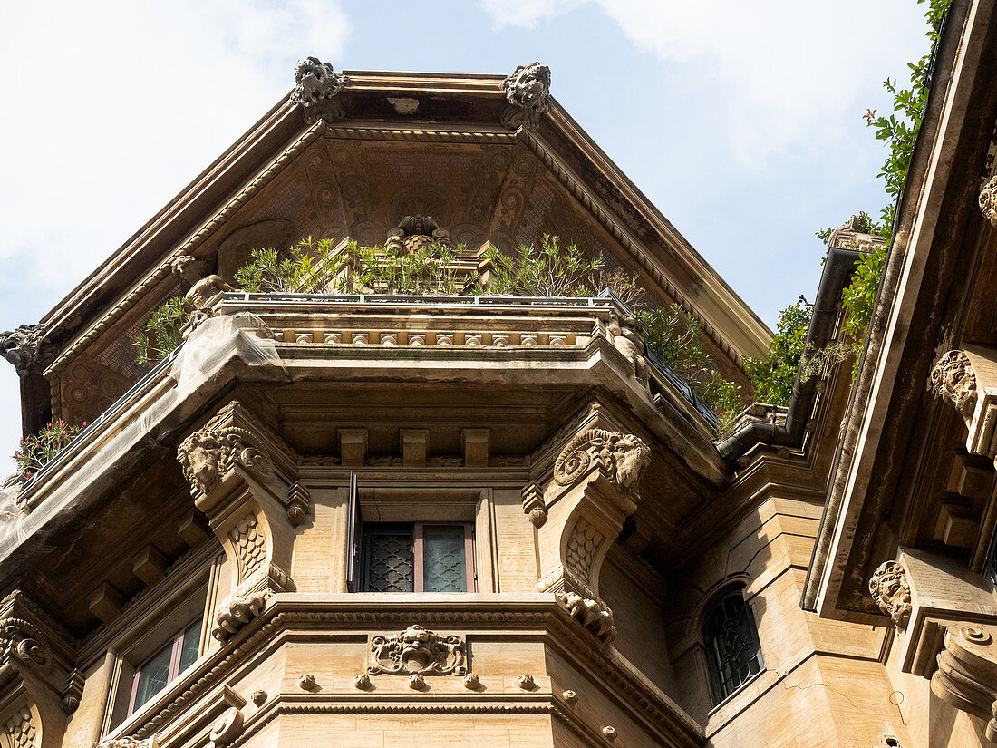 Quartiere Coppeda, Rome, Italy: Details of one of the towers of the Palazzi degli Ambasciatori, with sculptures in the facade