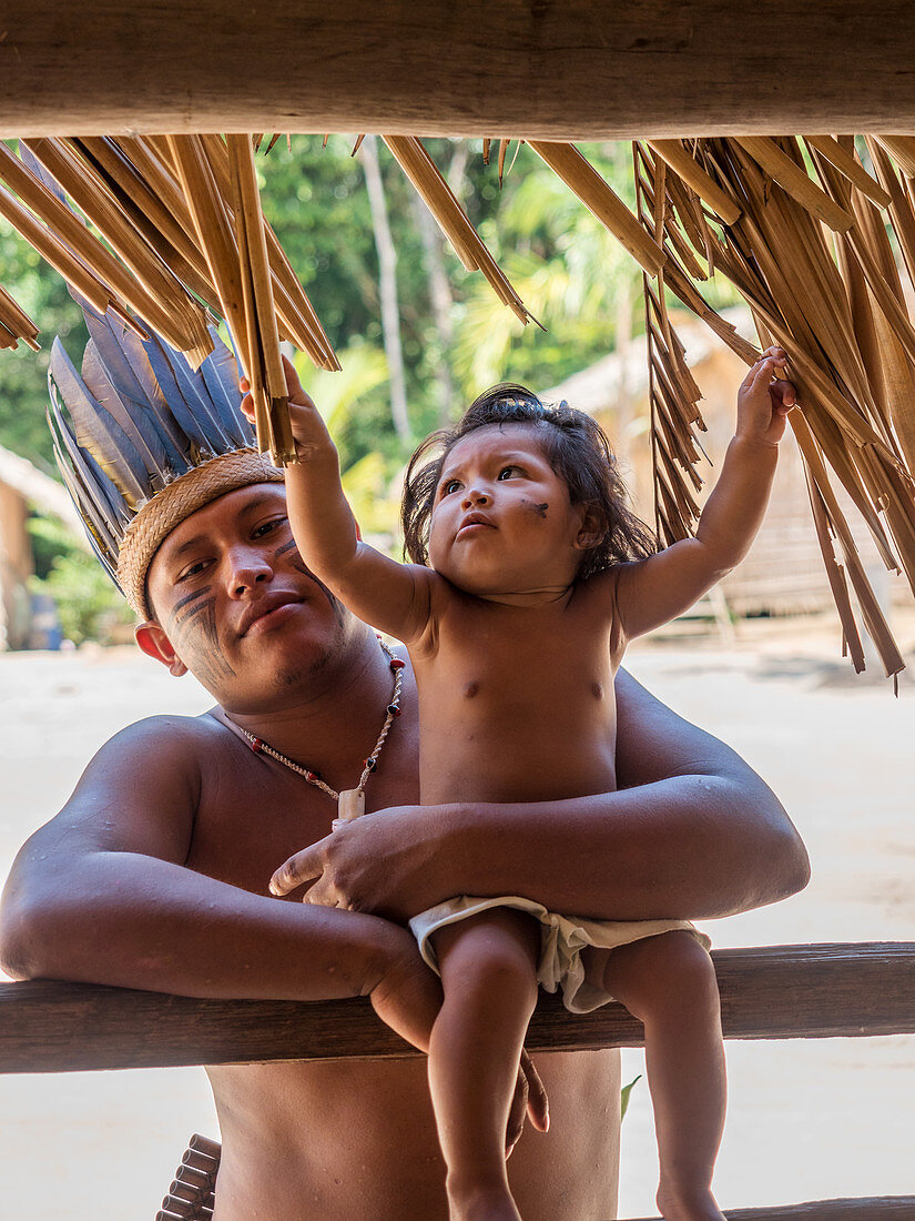 Man with toddler, indigenous people on the Amazon near Manaus, Nucleo Cultural Indigena Cipia, Amazon basin, Brazil, South America