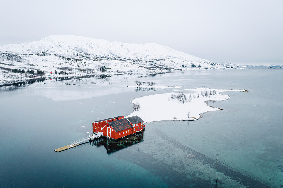 Elevated view of a solitary red house near Svolvaer, Lofoten Islands, Nordland, Norway.