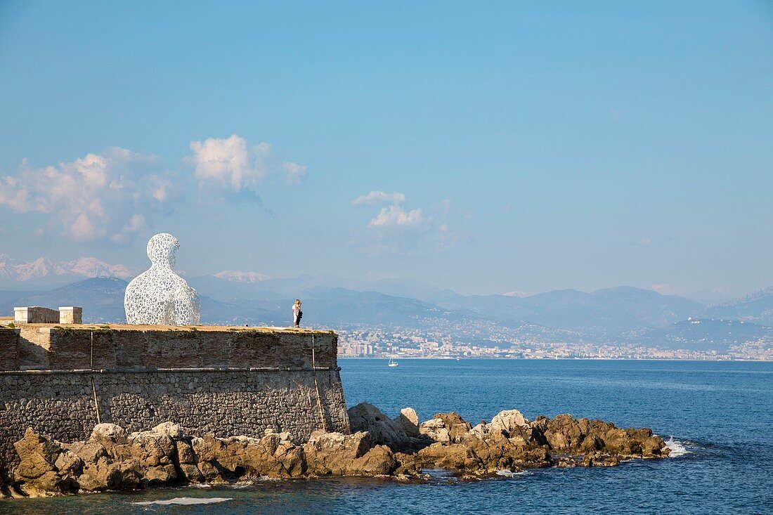 France, Alpes-Maritimes, Antibes, terrace of the bastion Saint-Jaume in the port Vauban, the transparent sculpture the "Nomad", created by the Spanish sculptor Jaume Plensa, the bust formed by letters, in background the Alps of the South covered with snow