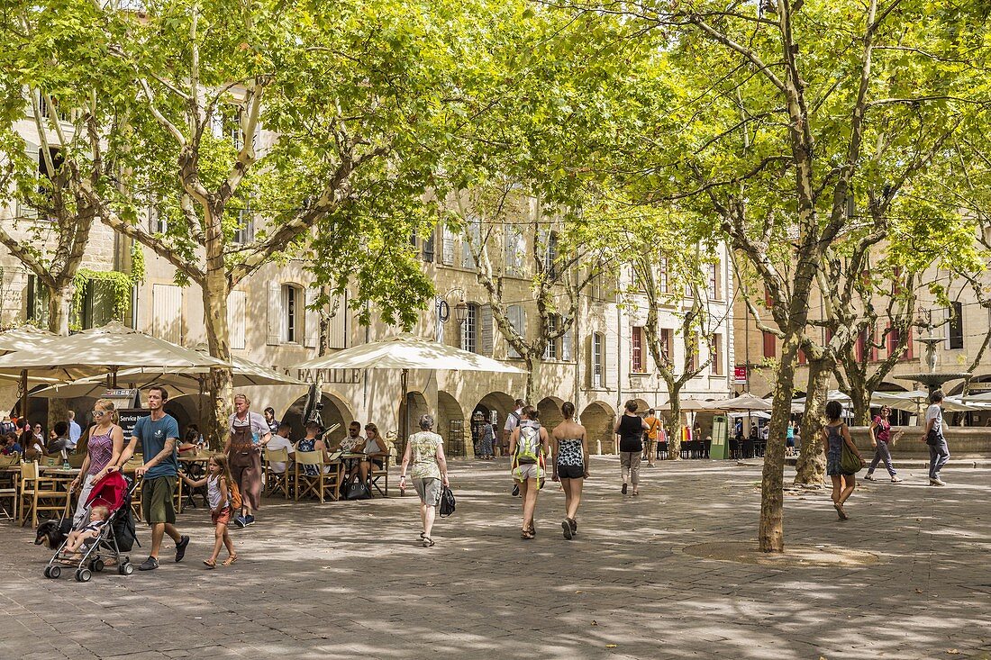 France, Gard, Pays d'Uzege, Uzes, the Place aux Herbes surrounded by arcaded houses and its outdoor cafes