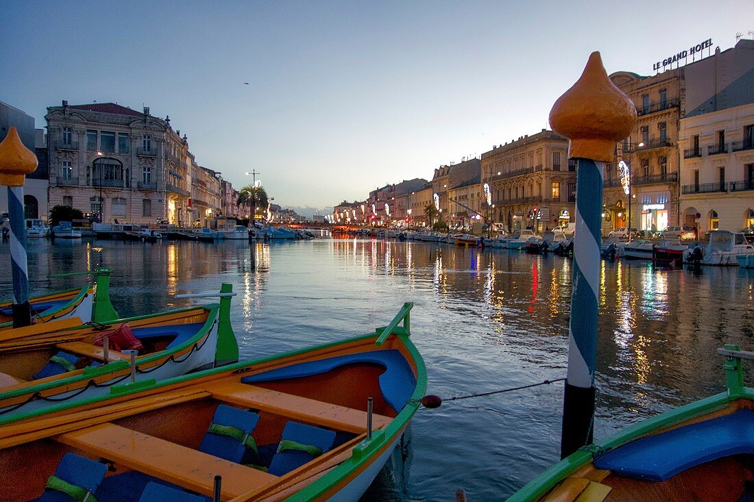 France, Herault, Sete, Quay Louis Pasteur, colored traditional boats moored to in pickets at dusk