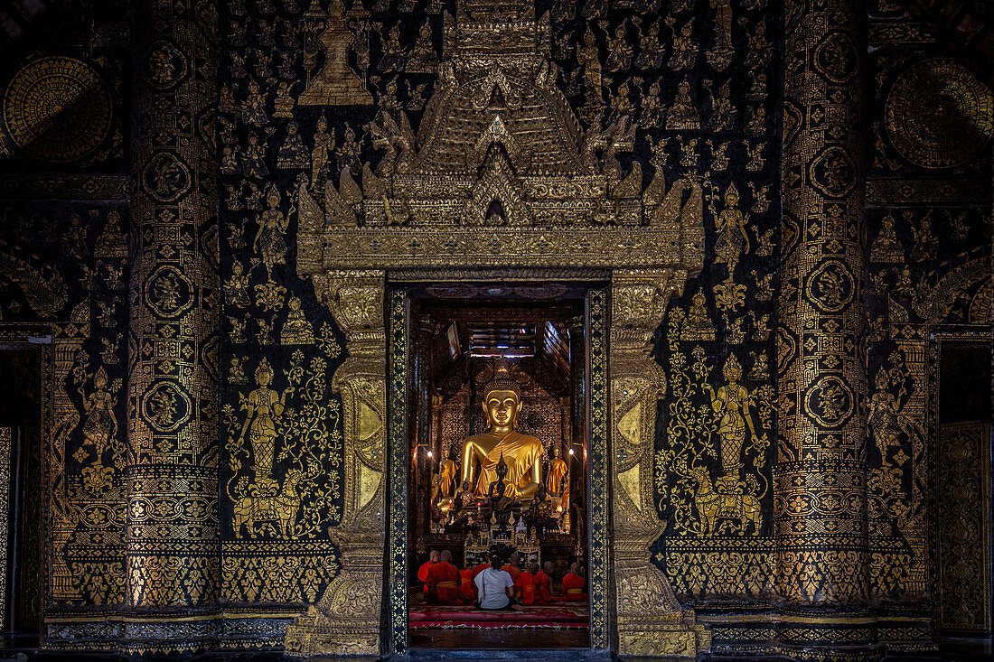 Monks chant at Wat Xieng Thong temple in Luang Prabang, Laos, Asia