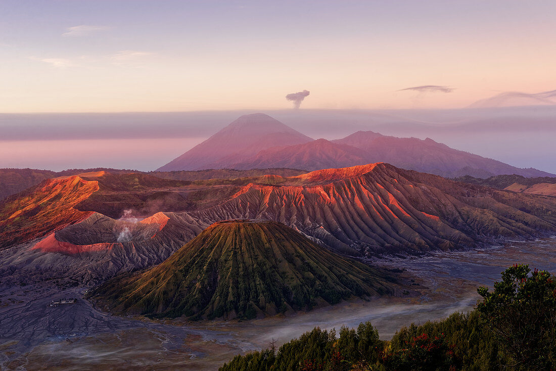 Dawn red from the eruption of the roughness over the landscape of the Bromo-Tengger-Semeru National Park, Java Island, Indonesia, Asia