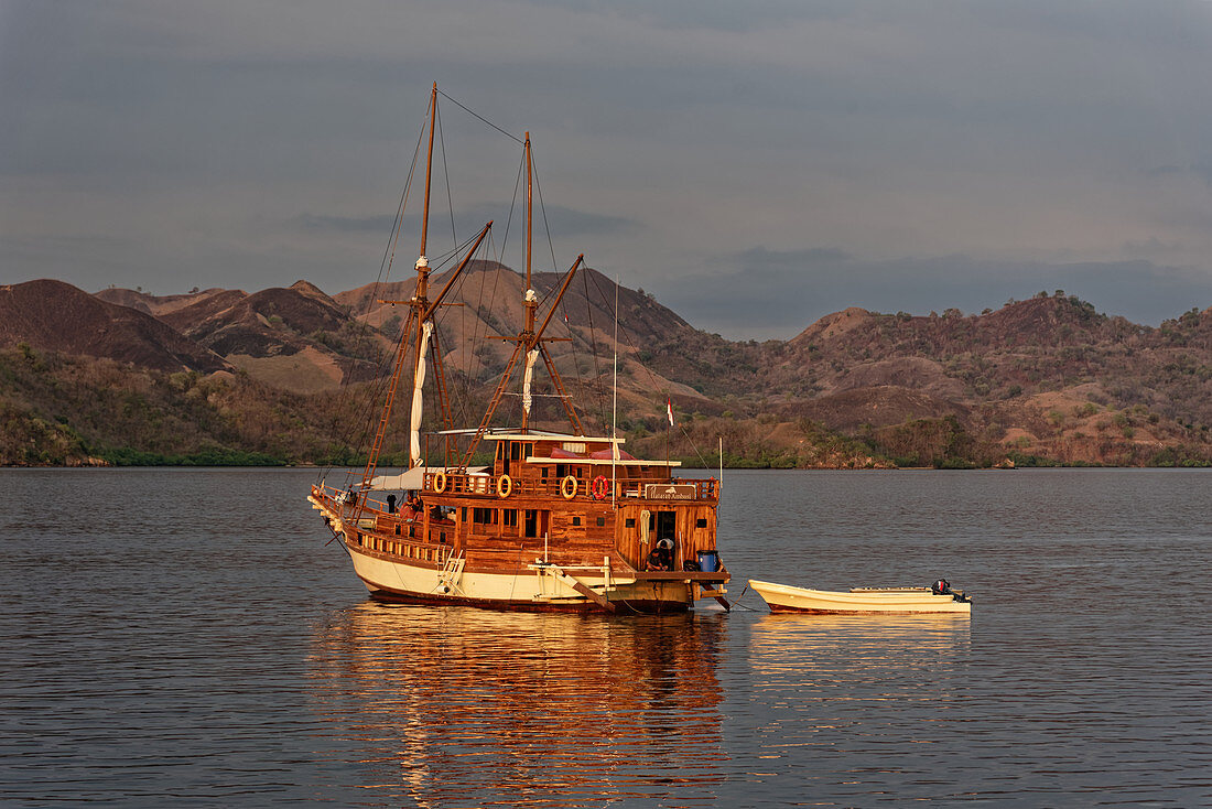Sailboat in front of the island of Rinca in the Komodo National Park, Komodo Island, Indonesia, Southeast Asia, Asia