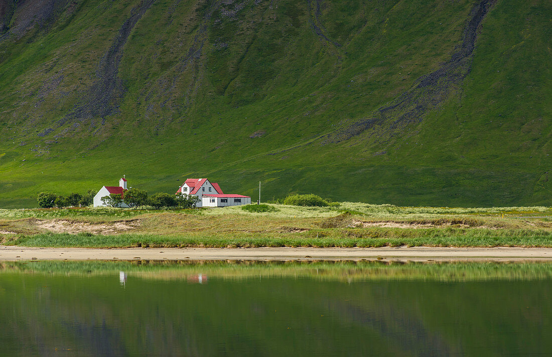 Church and farmland on Dyrafjordur, West fjords. Iceland.