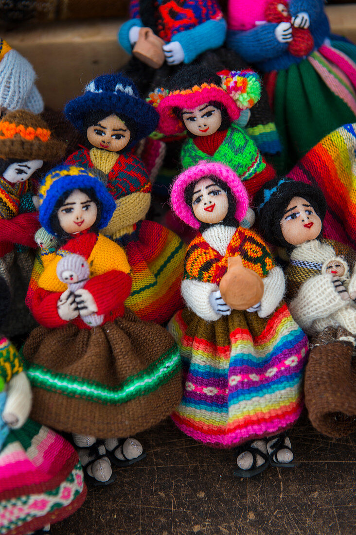 Street scene with souvenir dolls made out of colorful woven fabrics for sale in Humahuaca, a city in the valley of Quebrada de Humahuaca, Andes Mountains near Purmamarca, Jujuy Province, Argentina.