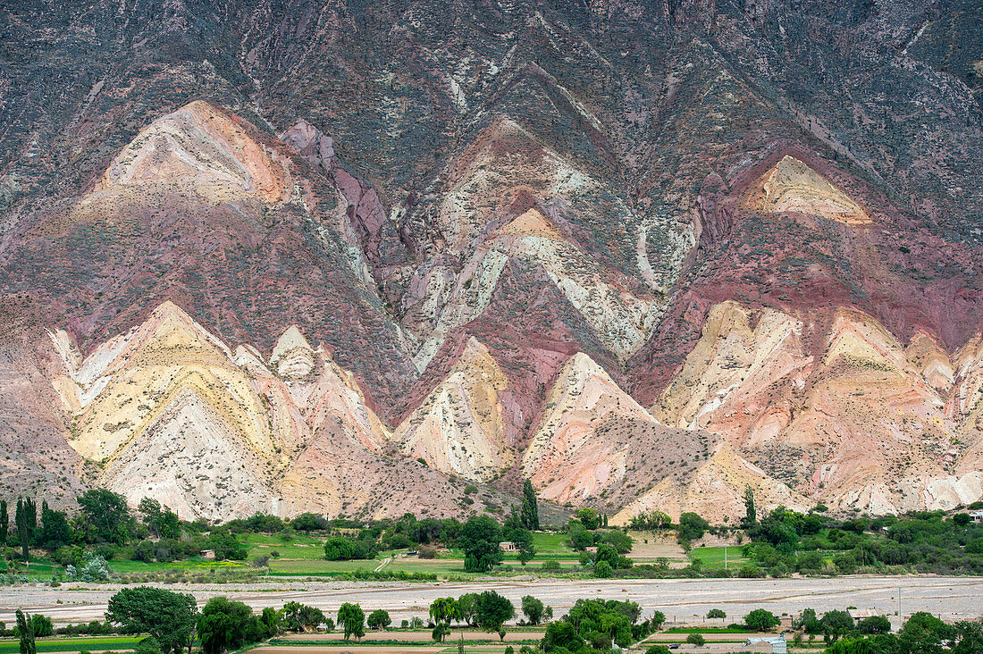 View of colorful rock formations and erosion near Tilcara in the valley of Quebrada de Humahuaca, Andes Mountains, Jujuy Province, Argentina.